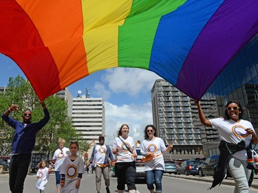 A large pride flag is carried down Broad St.  at the Queen City Pride Parade in Regina, Sask. on Saturday June. 25, 2016.