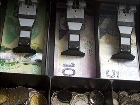 Canadian money in a cash register drawer.