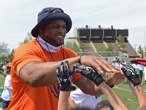 Chicago Bears linebacker Jerrell Freeman gives out some high-fives at the NFL's Play 60 initiative at the University of Regina on Saturday.