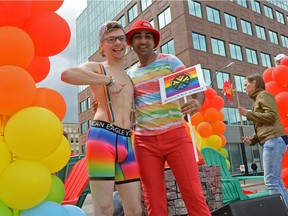 Chris Deboth, left, and Ahad Ahmed, right, pose on a float at the Queen City Pride Parade in Regina, Sask. on Saturday June. 25, 2016. MICHAEL BELL
