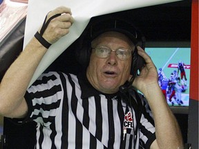 Head referee Jake Ireland pokes his head out from under the hood at the instant replay booth on the sidelines at Olympic Stadium during the CFL Eastern Final game between the Montreal Alouettes and the Toronto Argonauts in Montreal November 12, 2006.