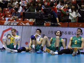 Former University of Regina Cougars libero Jacques Borgeaud (8) and three of his teammates on Australia's men's volleyball squad — (left to right) Nehemiah Mote, Jacob Ross Guymer and Thomas Edgar — react after they lost to Poland during an Olympic qualification tournament in Tokyo on Sunday. The loss eliminated Australia from contention for the 2016 Summer Olympics.