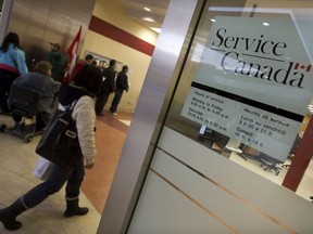 A woman enters the Service Canada location in Toronto in this file photo. The number of Employment Insurance recipients fell 1.7 per cent in April from the previous month in Saskatchewan.