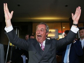 Leader of the United Kingdom Independence Party (UKIP), Nigel Farage (C) reacts as he leaves the Leave.EU referendum party at Millbank Tower in central London on June 24, 2016, as results indicate that it looks likely the UK will leave the European Union (EU).