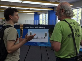 Cyclists John Klein, left, and Jim Elliott discuss the city's plans for a new cycle lane on Lorne Street.