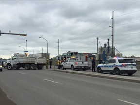 Police, firefighters and an ambulance crew at the scene of a collision on the overpass that goes over the Ring Road at Ross Avenue in northeast Regina.