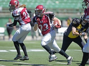 Regina Riot running back Carmen Agar carries the ball for some of her 228 yards during Western Women's Canadian Football League playoff action Sunday at Mosaic Stadium.