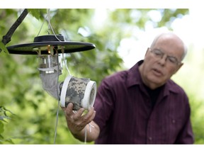 Provincial West Nile Virus Coordinator Phil Curry shows a Centre of Disease mosquito light trap with carbon dioxide at the T.C. Douglas building in Regina on Monday.