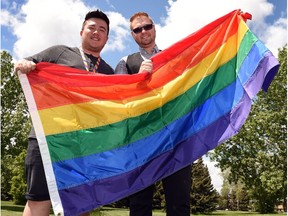 Dan Shier (L) and Jessie Ireland with a Pride flag, getting ready to kick off Pride Month for the LGBTQ community.