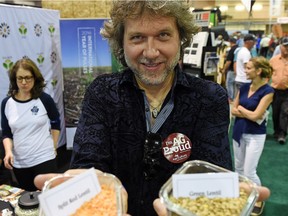 Chef Michael Smith, the Canadian ambassador for the International Year of Pulses, holds  split red lentils and green lentils at the Saskatchewan Pulse Growers display at Canada's Farm Progress Show in Regina .