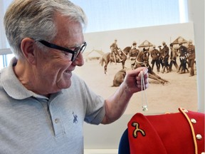 Al Nicholson, CEO of the RCMP Heritage Centre, holding a limited edition pendant by Hillberg & Berk that will be presented to the Countess of Essex on Thursday.