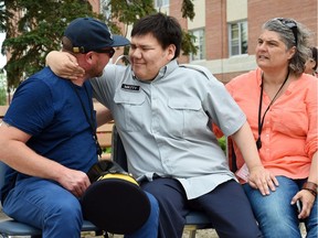 This photo from June 2016 shows Matthew Brandon (C) on his 25th birthday at RCMP Depot, where he was made an honorary member for the day. Visits to Depot are part of his weekly routine that have been disrupted by COVID-19. Also in the photo are his caregivers Chris (L) and Shannon Gardiner (R).