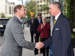 Prince Edward arrives at the Hotel Saskatchewan in Regina and is greeted by hotel manager Richard Main (R).