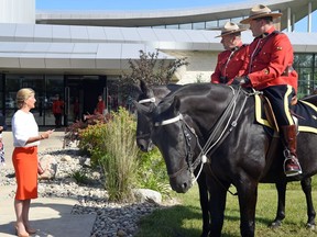 Sophie Rhys-Jones, the Countess of Wessex, chats with RCMP constables Dale Malbeuf on Salute (L) and Carmen Hunter on Turbo (R) out front of the RCMP Heritage Centre in Regina.