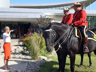 Sophie Rhys-Jones, the Countess of Wessex, chats with RCMP constables Dale Malbeuf on Salute (L) and Carmen Hunter on Turbo (R) out front of the RCMP Heritage Centre in Regina.