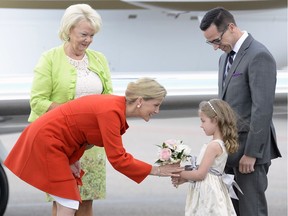 Countess Sophie receives flowers from and chats with five-year-old Aida Weaver at the Airport as her father Scott looks on.
