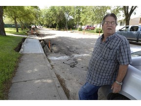 Larry Fuhr, homeowner stands in front of his home on  Bond Street, in front of his property where the sidewalk is paved asphalt on top of old concrete sidewalk. Larry and his wife Nancy lived in the house since 1984. They have been waiting to have the sidewalks paved since they moved in. The city has dubbed this paving tactic as a temporary fix, but many people in the neighbourhood continue to wonder if something permanent will happen.