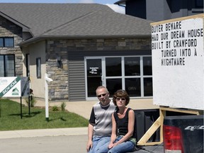Brad and Sharon Lenz with their sign in front of a Crawford Homes show home in Regina on June 6, 2016.