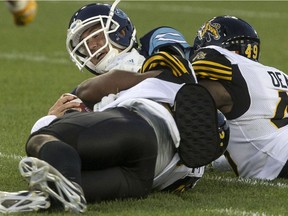 The Toronto Argonauts must find a way to protect quarterback Ricky Ray, who is shown being sacked by the Hamilton Tiger-Cats in opening-week CFL action.