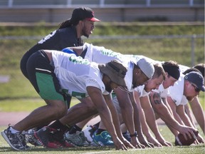 Backup quarterback Phil Sims practises working under centre with the Riders' offensive line during Friday's walkthrough.