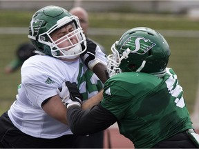 Aaron Picton (left), shown here during the Saskatchewan Roughriders' training camp in Saskatoon, is pondering his future after being cut by the Roughriders on Sunday.