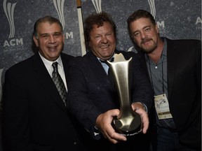 Troy Vollhoffer (centre), executive producer of the Craven Country Jamboree and the Country Thunder festivals, displays the ACM award for festival of the year in 2014 won by Country Thunder Wisconsin.