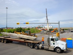 A piece of the overpass is loaded onto a truck at Ring Road and Victoria Ave. in Regina, Sask. on Saturday July 9, 2016.