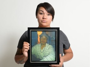 Amina Wahweaye holds a portrait of her brother Calvin (Thursday July 14, 2016. MICHAEL BELL)