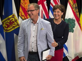 Premier Brad Wall, left and British Columbia Premier Christy Clark differ on the merits of a carbon tax. B.C. has one, Saskatchewan doesn't.