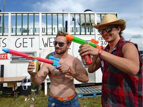 Chris Ripplinger and Alex Nau (right) brandish their beer-shootin' guns in front of the Booze Cruiser in the Craven Country Jamboree campgrounds.