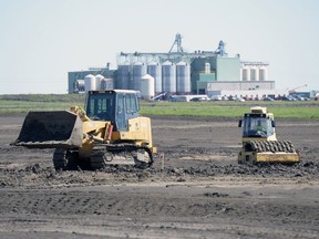 Crews work on a drainage system that will lay underneath the ball diamonds of the new Pacer Park just off Tower Road in Regina on July 19, 2016.