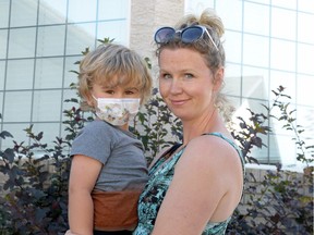 Erica Honoway holds her son Lincoln at their home on July 28, 2016. In February, the family found out that Lincoln has aplastic anemia, and needs a bone marrow transplant to get better. Lincoln's immune system is compromised, so needs to wear a mask to protect from germs.