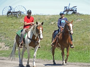 Haydar Cappo, left, and Bradley Episkenew, right, ride horses at Spirit Horse Camp held at Muscowpetung Saulteaux First Nation, Sask. on Thursday June. 30, 2016. MICHAEL BELL