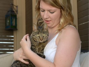 Hayley Toniello holds her cat Miss Kitty at her home in Regina on July 26, 2016.
