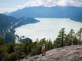 A man climbs down a rock face on the Stawamus Chief mountain above the waters of Howe Sound in Squamish B.C., one of the destinations of the New Yotina Friendship Centre's healing journey.