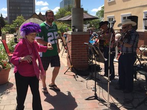 Maxine McClellan dances with Saskatchewan Roughriders alumnus Rob Bresciani to the old-time music of Young At Heart -- Joyce Young and Ol' Bill Young -- on Thursday, July 28, 2016, at the Renaissance Retirement Residence.