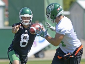 Mitchell Gale (8) pitches the ball to Riders tailback Matt Walter during a recent practice.