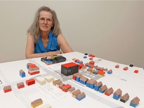 Molly Moss sits a model of the corner of 13th Ave. and Elphinstone St. at her home in Regina, Sask. on Friday July 15, 2016. Moss is part of Protect Cathedral, a group concerned about a possible development that may happen at the corner of 13th Avenue and Elphinstone Street. MICHAEL BELL