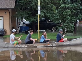 Estevan residents take their canoe out onto the flooded street on July 10, 2016 following a torrential downpour.