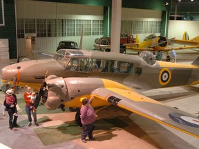 Patrons of the Moose Jaw Western Development Museum look over an Avro Anson MK1 of the type used for bomber training in the British Commonwealth Air Training Plan in Saskatchewan.