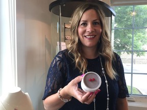 Rachel Mielke, founder and CEO of Hillberg and Berk, holds a pair of Olympic sparkle ball earrings.
