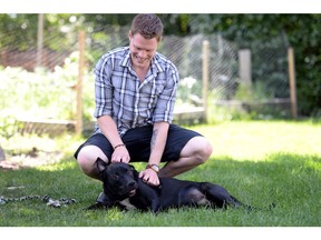 Jon Claggett with Tyson, a Lab/Rottweiler mixed-breed dog he just received last week as a result of it being surrendered in Quebec.  Claggett is looking after the dog until a suitable family is available to adopt him.