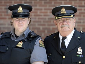 Transgender deputy sheriff Diane Maguire, left, and Ben Prystay, manager of court security, outside of Regina Provincial Court in Regina.