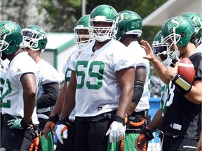 Rookie offensive lineman Josiah St. John, who held out after being the first pick overall in the 2016 CFL draft before signing late last week, practised for the first time with the Saskatchewan Roughriders on Monday.