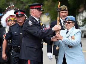 Torchbearers Leo Von Falkenhausen (left) retired sergeant, Royal Regina Rifles who served in Bosnia and Afghanistan hands off the torch to Janet Bennett who served in Egypt, Germany, the Gulf War and Afghanistan on Dewdney Avenue in Regina. The torch will be carried from Regina to Nipawin for the Run to Remember.