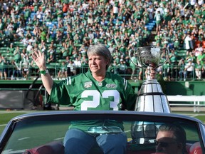 Ron Lancaster's daughter, Lana Mueller, is shown with the Grey Cup on July 16 when the Saskatchewan Roughriders paid tribute to their 1966 championship team.