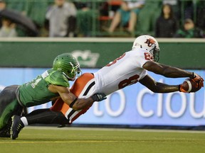 A.C. Leonard, right, scores one of his two touchdowns for the B.C. Lions against the Saskatchewan Roughriders on July 17, 2015. Leonard has since been converted to defensive end and will play for the Roughriders against the Lions on Saturday.