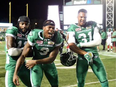 From left, Saskatchewan Roughriders defensive back Ed Gainey, wide receiver Ricky Collins and defensive back Justin Cox celebrate at the end of the game that saw the Riders win the game 30-29 over the Ottawa Redblacks at Mosaic Stadium in Regina. DON HEALY /