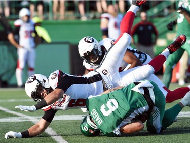 Saskatchewan Roughriders defensive back Rob Bagg makes a catch under pressure from Ottawa Redblacks defensive back Antoine Pruneau during CFL action at Mosaic Stadium in Regina.