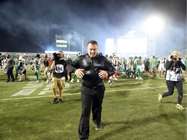 Saskatchewan Roughriders head coach Chris Jones walks off the field after being drenched by Gatorade at the end of the game that saw the Riders win the game 30-29 over the Ottawa Redblacks at Mosaic Stadium in Regina.